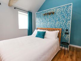 A bedroom with a bed and curtains at The Homestead in Moorsholm