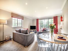 A living room with sofa and dining area at Bargany (Pet) in Dailly