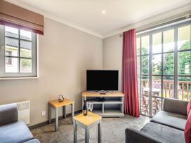 A living room with a television and sofa at Bargany (Pet) Dailly