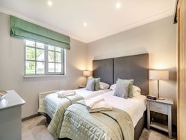 A bedroom with twin beds and a nightstand at Bargany (Pet) Dailly