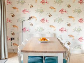 A dining room with a table and fruit bowl at 4C2 Summerleaze Garden Cottage 2 Spa Bude
