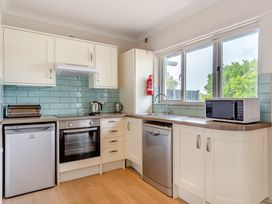 A kitchen with appliances and cabinets at 4C2 Summerleaze Garden Cottage 2 Spa Bude