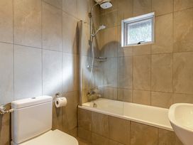 A bathroom with a bathtub and toilet at 4C2 Summerleaze Garden Cottage 2 Spa in Bude