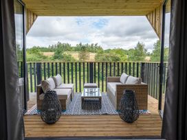 An outdoor seating area with couches and a coffee table at Orka 1.0 (Pet) Dumfries