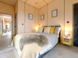 A bedroom with a bed and bedside table at Orka 1.0 (Pet) Dumfries