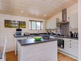 A kitchen with cabinets and a countertop at Hurricane Lodge in Fair Oak