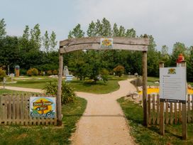 A golf course entrance with signs and pathways at Hurricane Lodge in Fair Oak