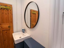 A bathroom with a sink and mirror at The White House in Norwich