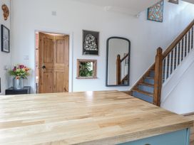 A kitchen with a table and a door at The White House in Bracondale