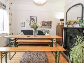 A dining room with a table and benches at The White House in Bracondale