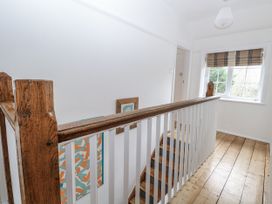 A hallway with staircase and window at The White House in Bracondale