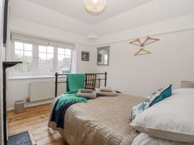 A bedroom with a bed and chair at The White House in Bracondale