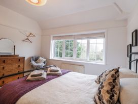 A bedroom with a bed and window at The White House in Bracondale