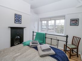 A bedroom with a bed and decorated wall at The White House in Bracondale