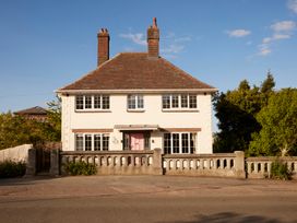 A house with two chimneys and a pink door at The White House, Riverside Retreat Bracondale