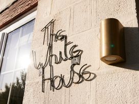 The White House sign on a wall with a light fixture at The White House, Riverside Retreat