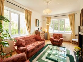 A living room with a sofa and armchair at The White House, Riverside Retreat in Bracondale