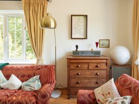 A living room with a sofa and a drawer chest at The White House, Riverside Retreat Bracondale