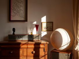 A living room corner with a record player and vases at The White House, Riverside Retreat, Bracondale