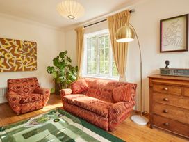 A living room with a sofa and armchair at The White House, Riverside Retreat Bracondale