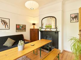 A living room with a table and sofa at The White House, Riverside Retreat in Bracondale