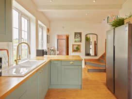 A kitchen with a sink and refrigerator at The White House, Riverside Retreat in Bracondale