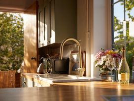 A kitchen with a sink and microwave at The White House, Riverside Retreat Bracondale