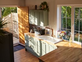 A kitchen with sink, kettle, and microwave at The White House, Riverside Retreat Bracondale