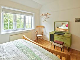 A bedroom with a window and a chair at The White House, Riverside Retreat in Bracondale