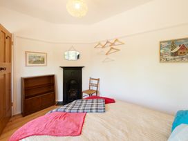 A bedroom with a bed and shelf at The White House, Riverside Retreat in Bracondale