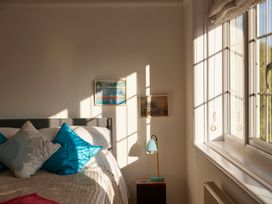 A bedroom with a bed and lamp at The White House, Riverside Retreat in Bracondale