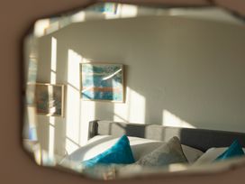 A bedroom with a bed and framed paintings at The White House, Riverside Retreat in Bracondale