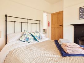 A bedroom with a bed and towels at The White House, Riverside Retreat in Bracondale
