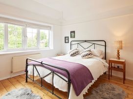 A bedroom with a bed and a nightstand at The White House, Riverside Retreat in Bracondale