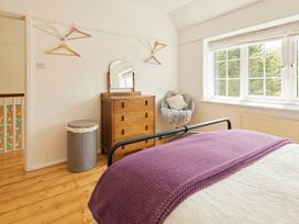 A bedroom with a bed and dresser at The White House, Riverside Retreat in Bracondale