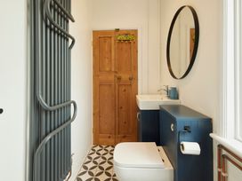 A bathroom with a sink and toilet at The White House, Riverside Retreat in Bracondale