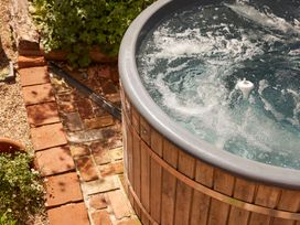 A hot tub with water and bubbles at The White House, Riverside Retreat Bracondale