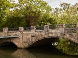 A bridge over water with trees in the background at The White House, Riverside Retreat, Bracondale