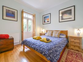 A bedroom with a bed and bedside tables at The Old Signal House in Torpoint