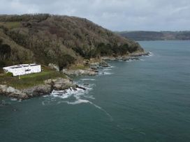 A house on rocky shore near water at The Old Signal House in Torpoint