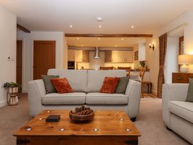 A living room with a sofa and coffee table at Grange Cottage in Coldridge