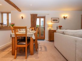 A dining room with a table and chairs at Grange Cottage in Coldridge
