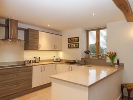 A kitchen with cabinets and appliances at Grange Cottage in Coldridge
