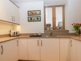 A kitchen with a sink and toaster at Grange Cottage in Coldridge