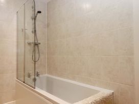 A bathroom with a bathtub and shower at Grange Cottage in Coldridge