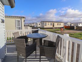 A patio with a table and chairs at CG 55 