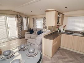 A living room with a sofa and dining set at CG 55