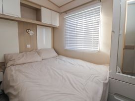 A bedroom with a bed and storage cabinets at CG 55