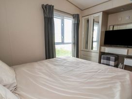 A bedroom with a bed and television at CG 55 