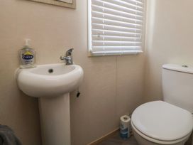 A bathroom with a sink and toilet at CG 55